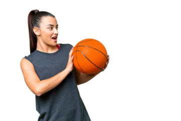 Young beauty woman over isolated chroma key background playing basketball