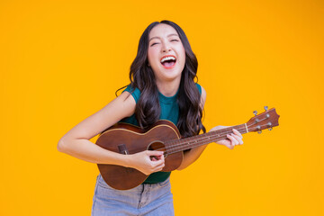 Fototapeta ready to party cheerful asian female woman signing joy fun toothy smile big laugh wearing casual cloth freshness action pose pretending perform in concert studio shot on yellow background obraz