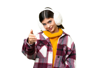 Young Russian woman wearing winter muffs over isolated chroma key background shaking hands for closing a good deal