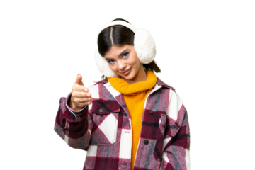 Young Russian woman wearing winter muffs over isolated chroma key background shaking hands for closing a good deal