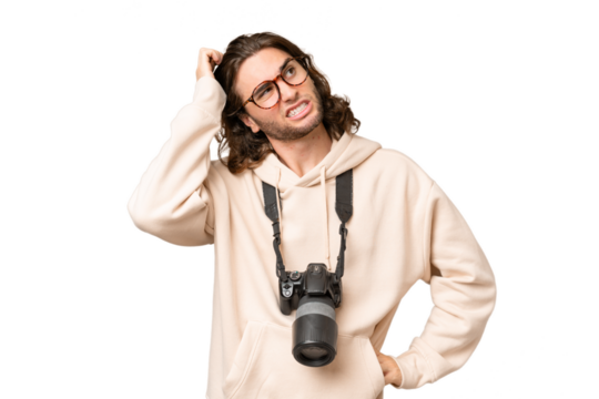 Young photographer man over isolated background having doubts and with confuse face expression