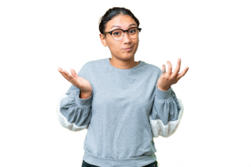 Young Uruguayan woman over isolated chroma key background having doubts while raising hands