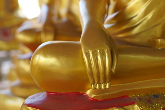 Golden Buddha hands in temple, Thailand