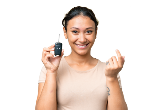 Young Uruguayan woman holding car keys over isolated chroma key background inviting to come with hand. Happy that you came