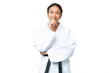 Young Uruguayan woman doing karate over isolated chroma key background having doubts and thinking