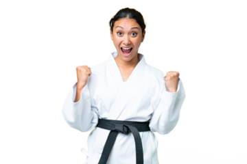 Young Uruguayan woman doing karate over isolated chroma key background celebrating a victory in winner position