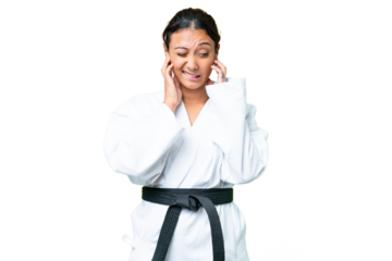 Young Uruguayan woman doing karate over isolated chroma key background frustrated and covering ears