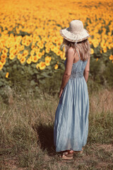 Woman looking at beautiful sunflower field