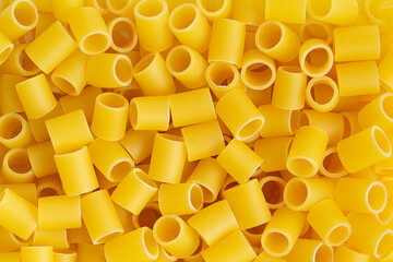Italian pasta canneroni lisci background. Top view, close up.