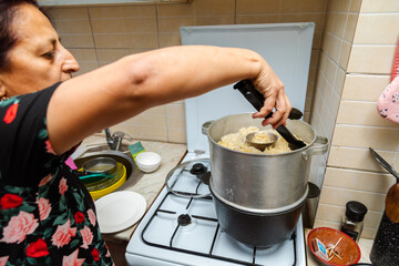 Closeup of dish with cooking manti (dumplings) on a stove
