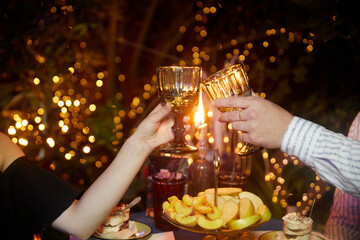 Couple clinking glasses of champagne at romantic dinner in restaurant, closeup