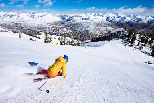 A woman skiing fresh groomers.