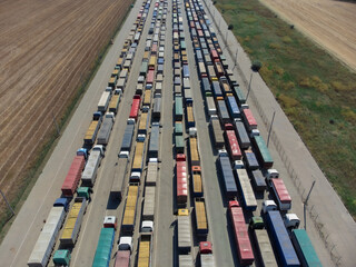 Trucks standing in line at the port to unload grain. Transportation and logistics concept.