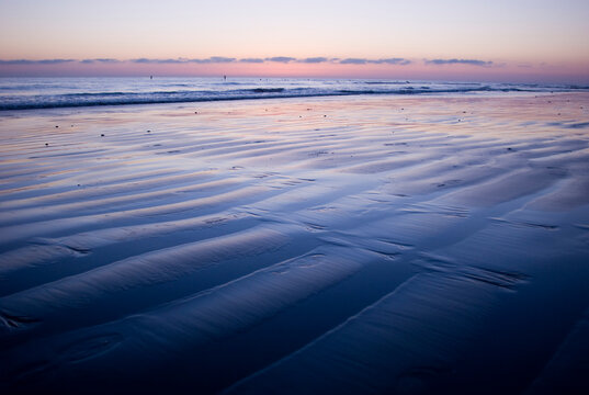 Ripples in the wet sand on a beach at sunset. Encinitas, California.