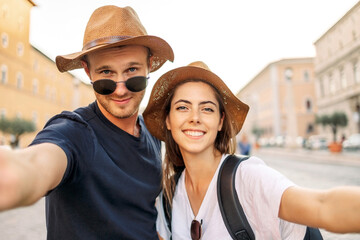 Happy Young couple taking selfie portrait with smartphone mobile outdoor. Tourism, friendship, youth and weekend activities concept. Close up portrait. Tourism, selfie photos, bloggers