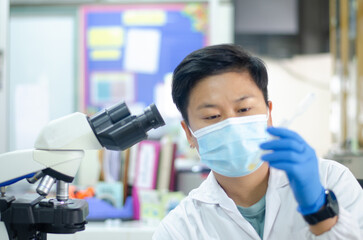 Asian scientists working in laboratory.