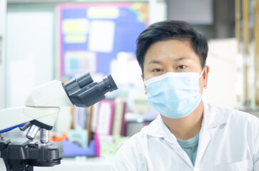 Asian scientists working in laboratory.