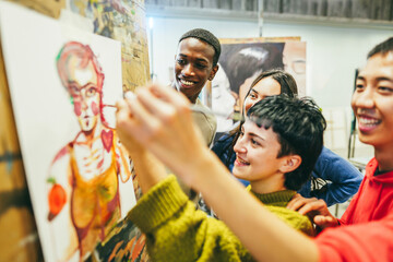 Multiracial students painting inside art room class - Focus on african guy face