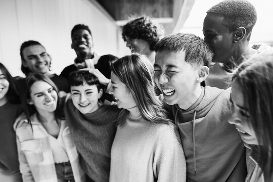 Young group of students friends having fun outdoor - Focus on asian guy face - School lifestyle concept - Black and white editing
