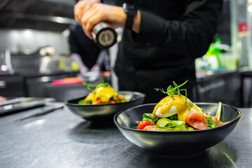 Chef in restaurant kitchen cooking salad