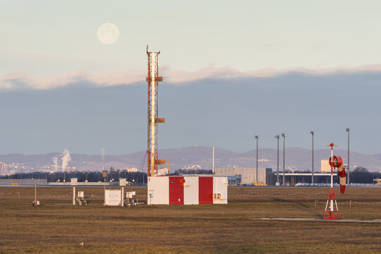 Airport infrastructure with a weather station and antennas for the instrumental landing system of the runway