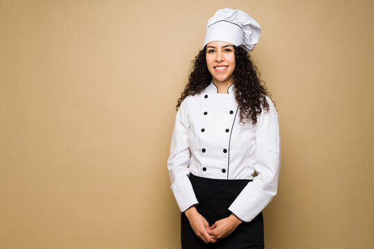 Smiling woman chef with curly hair