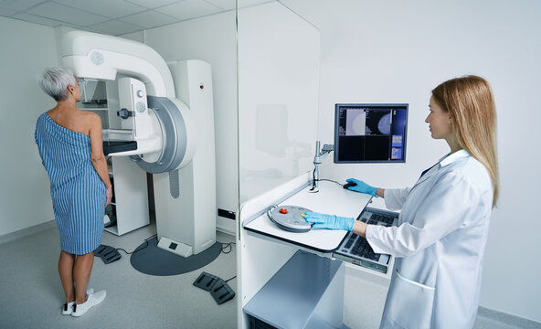 Mammography, mammogram procedure. Preventive examination of senior woman by mammologist with imaging machine to receive mammogram