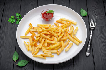 Appetizing side dish - French fries with ketchup in a white plate