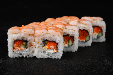 Shrimp sushi roll on black concrete background