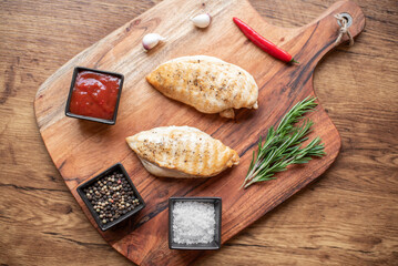 grilled chicken fillet on wooden background