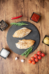 grilled chicken fillet on wooden background