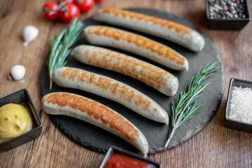 grilled sausages with spices on a rustic background