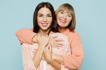 Smiling lovely fun satisfied elder parent mom with young adult daughter two women together wearing...