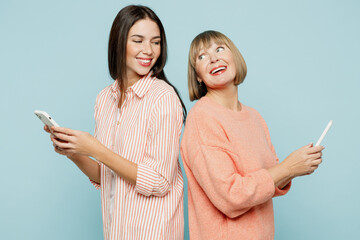 Side view elder parent mom with young adult daughter two women together wear casual clothes hold in...