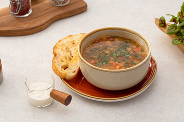 Portion of sorrel soup with grilled veal and toasted bread