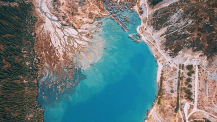 Top view of the turquoise water of a mountain lake. Clean clear water with streaks on the bottom....