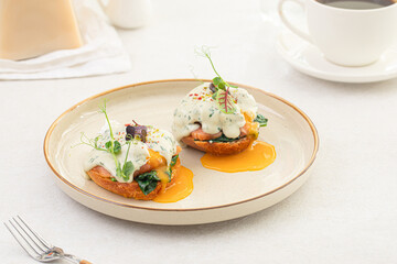 Side view on portion of benedikt egg with dor-blue sauce