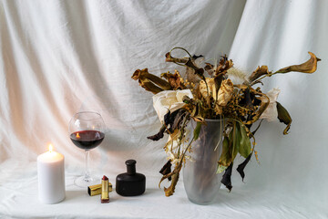 still life photo with beautiful dry colorful flowers in a vase, cosmetic accessories