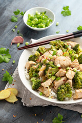Stir fried Chicken and Broccoli with rice in white plate