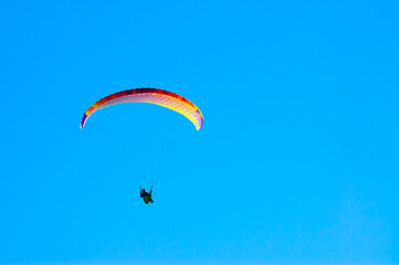 paraglider against the blue sky