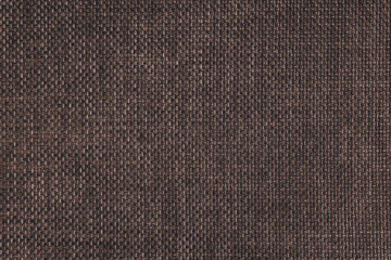 Jacquard woven upholstery, dark brown coarse fabric texture. Textile background, furniture textile material, wallpaper, backdrop. Cloth structure close up.