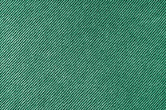 Texture background of velours green fabric. Upholstery velveteen texture fabric, corduroy furniture textile material, design interior, decor. Ridge fabric texture close up, backdrop, wallpaper.