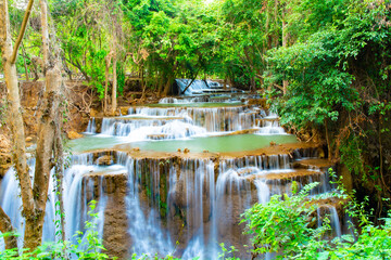 Fototapeta na wymiar Amazing colorful waterfall in national park forest during spring,beautiful deep forest in Thailand,technic long exposure, during vacation and relax time.