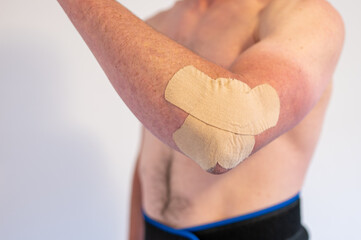 Physiotherapy treatment with therapeutic tape for elbow pain. 