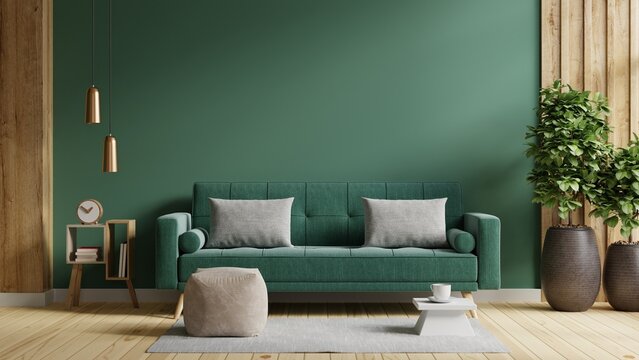 Wall mockup in dark tones with green sofa and decor in living room. © Vanit่jan