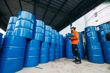 Male worker inspection record drum oil stock barrels blue horizontal or chemical - obrazy, fototapety, plakaty