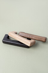 Wooden furniture handles on green background. Handle-bracket. Handles of different colors