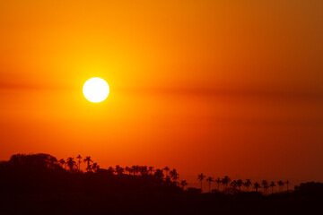 The setting sun ignites the sky into a myriad of beautiful colours at sunset.