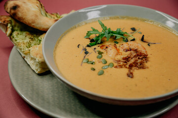 Vegetable soup with shrimps and bread.