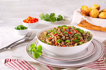 Vegan Hopping John with Brown Rice and corn bread muffins; copy space